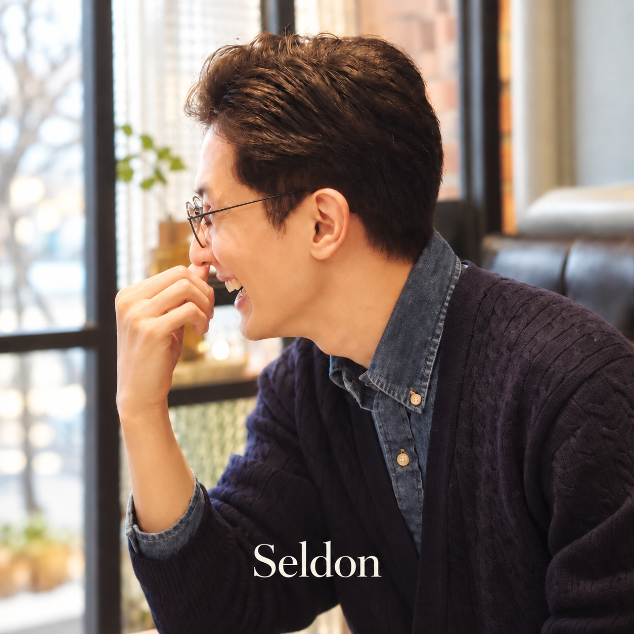 Seldon smiling in a cafe